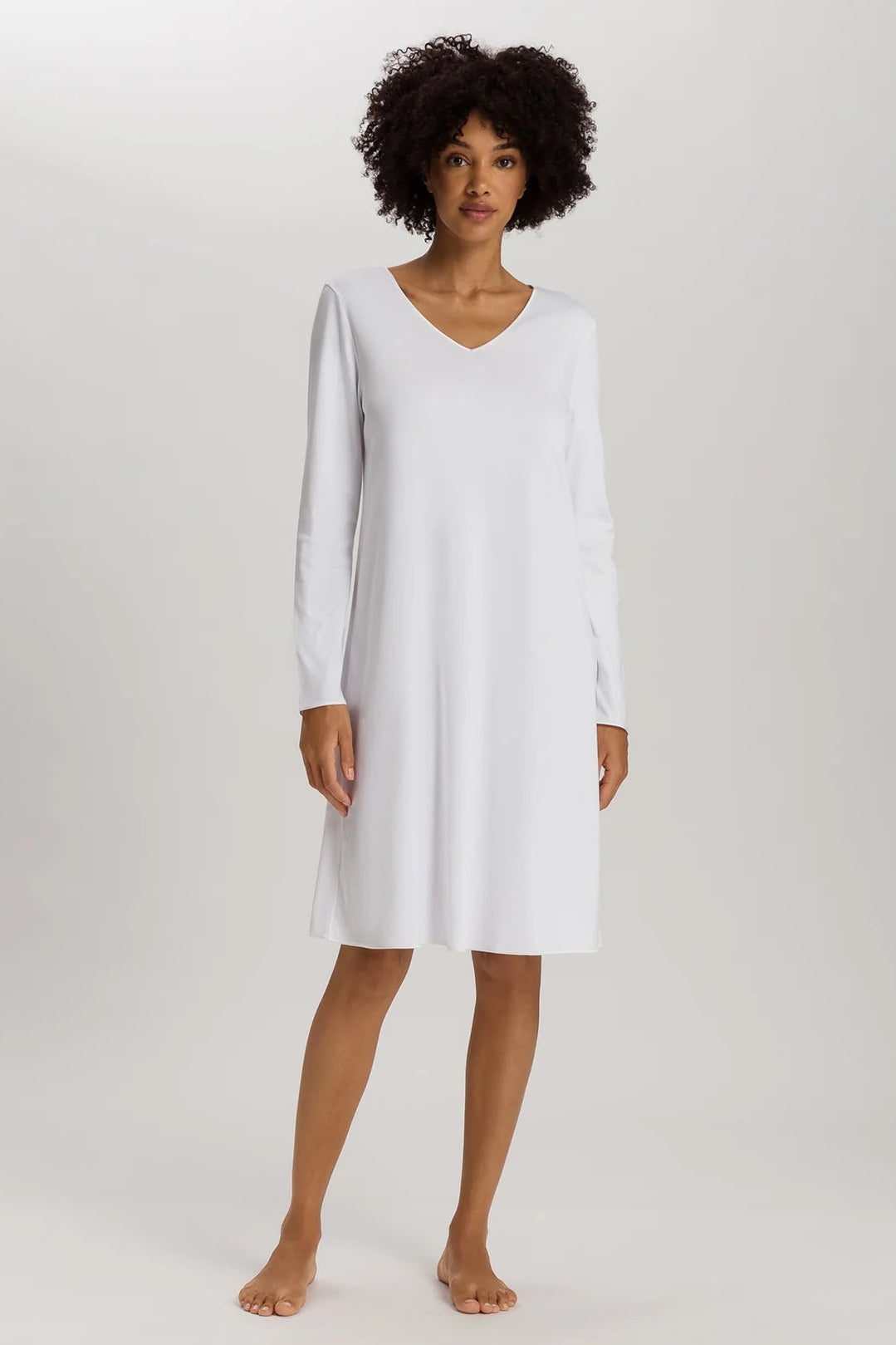 woman wearing a white v-neck long sleeve A-line knee length night dress