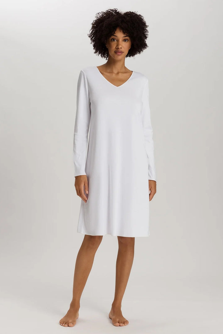 woman wearing a white v-neck long sleeve A-line knee length night dress