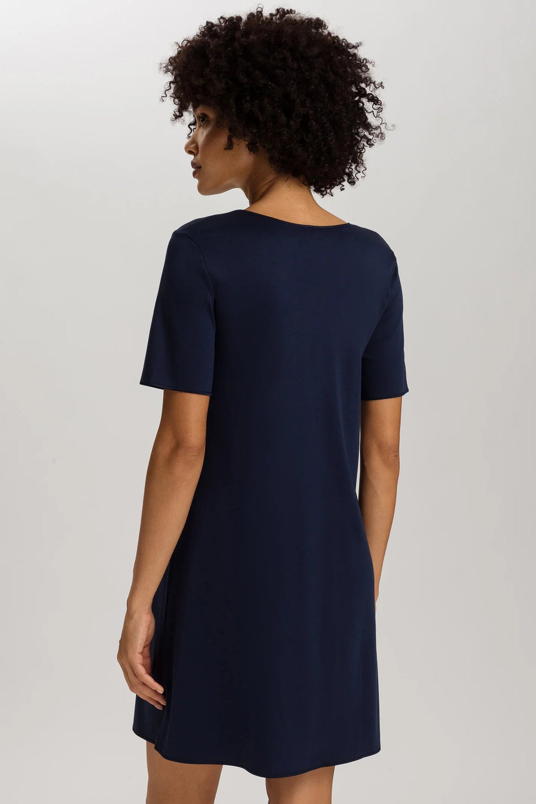 woman wearing a navy v-neck short sleeve A-line night dress