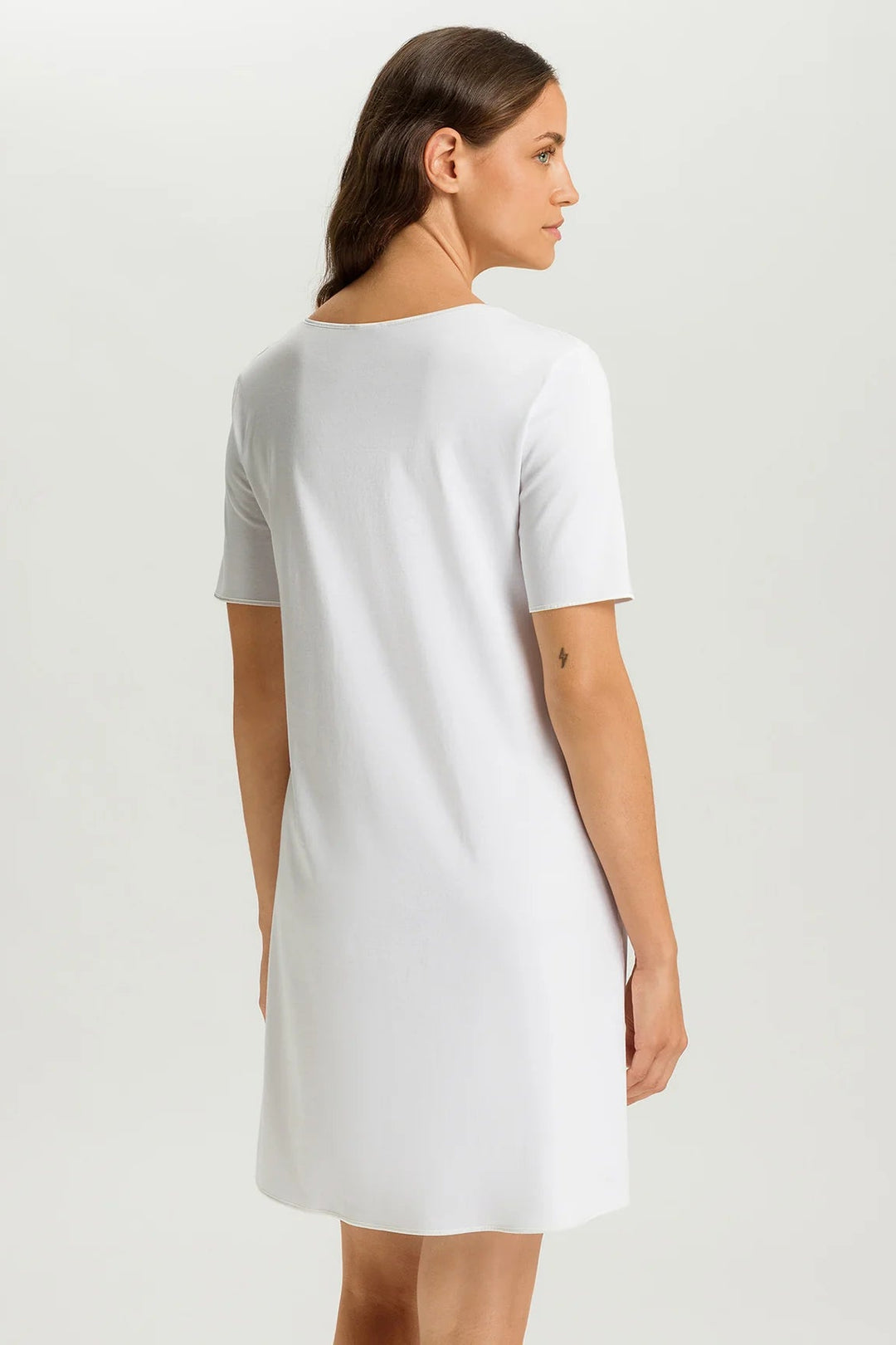 woman wearing a white v-neck short sleeve A-line night dress
