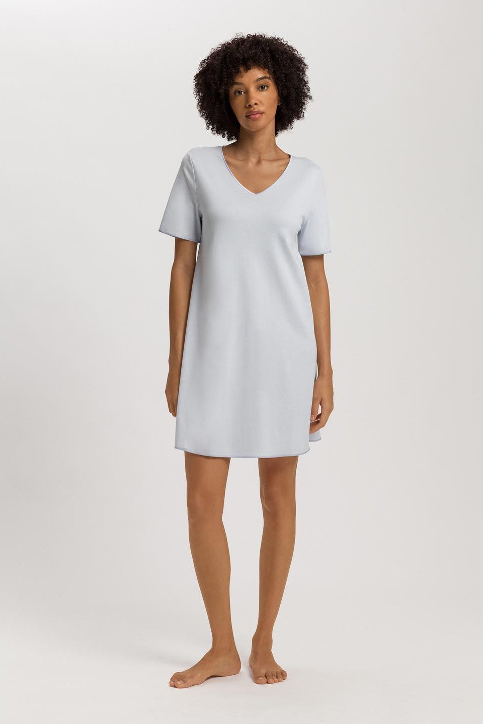 Woman wearing a light blue nightgown on a white background