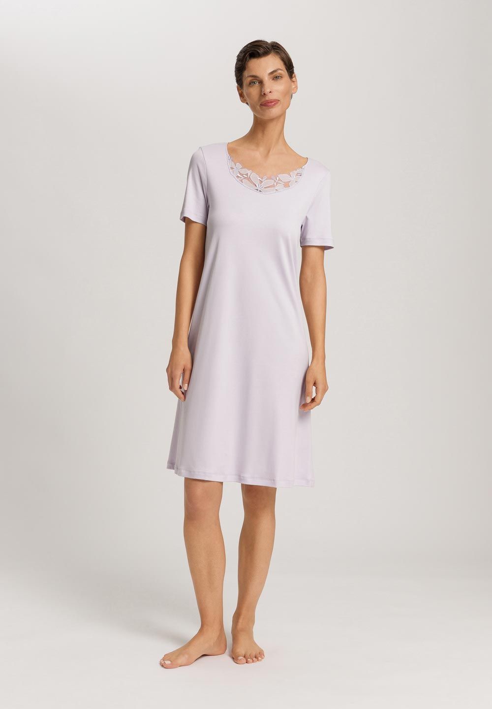 Woman wearing a light purple nightshirt on a white background