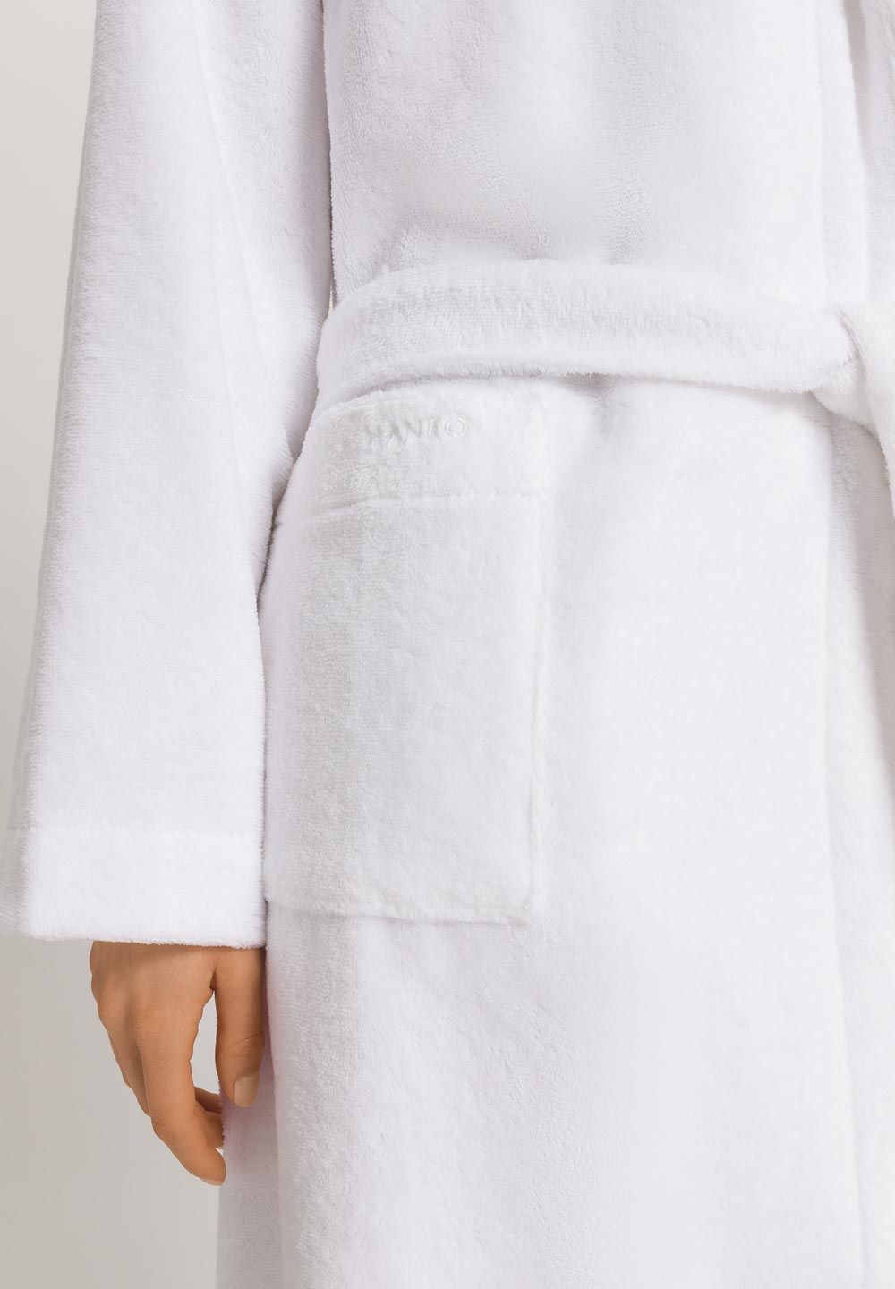 White bathrobe with a hand partially visible at the bottom