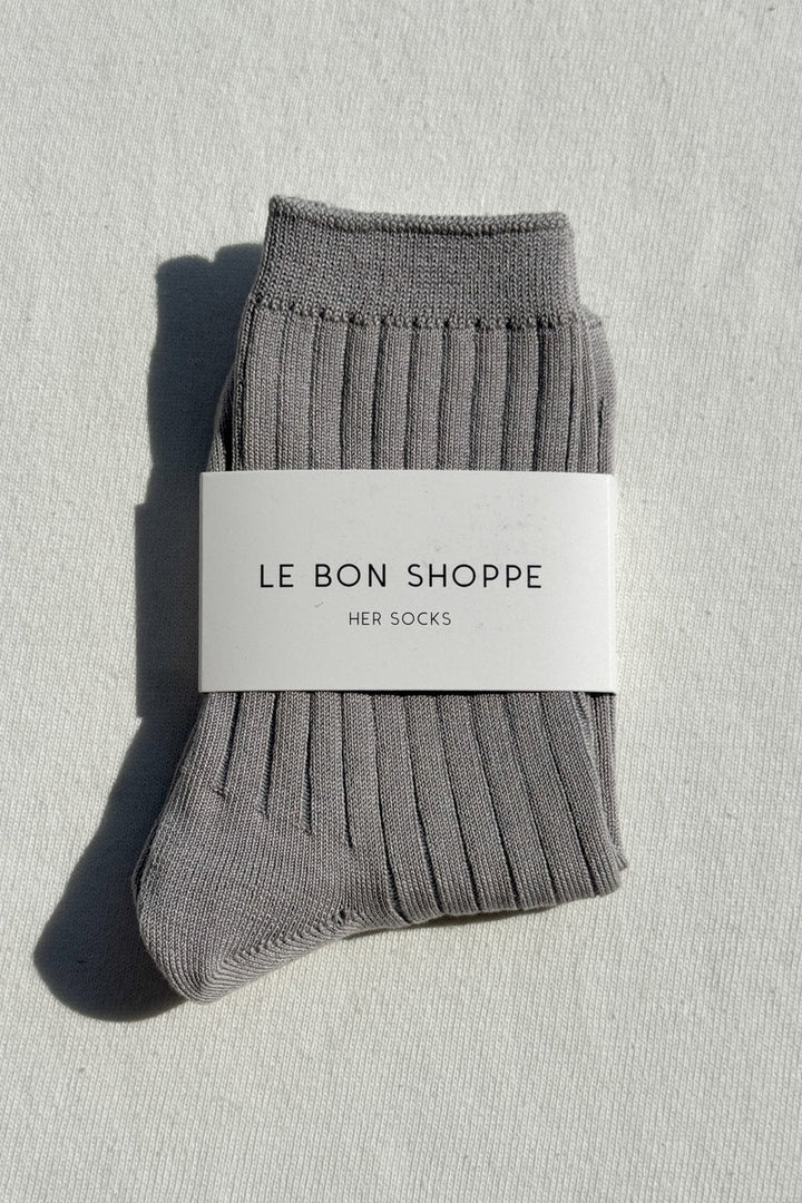 Gray socks with a 'Le Bon Shoppe' label on a light gray background
