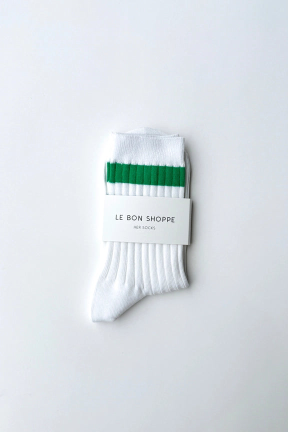White socks with green accents and a 'Le Bon Shoppe' label on a white background