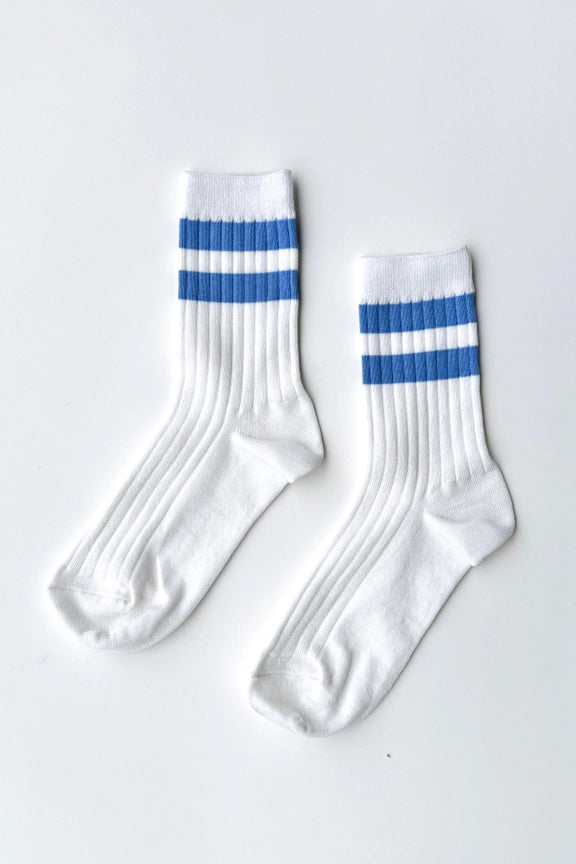 White socks with blue stripes on a light gray background