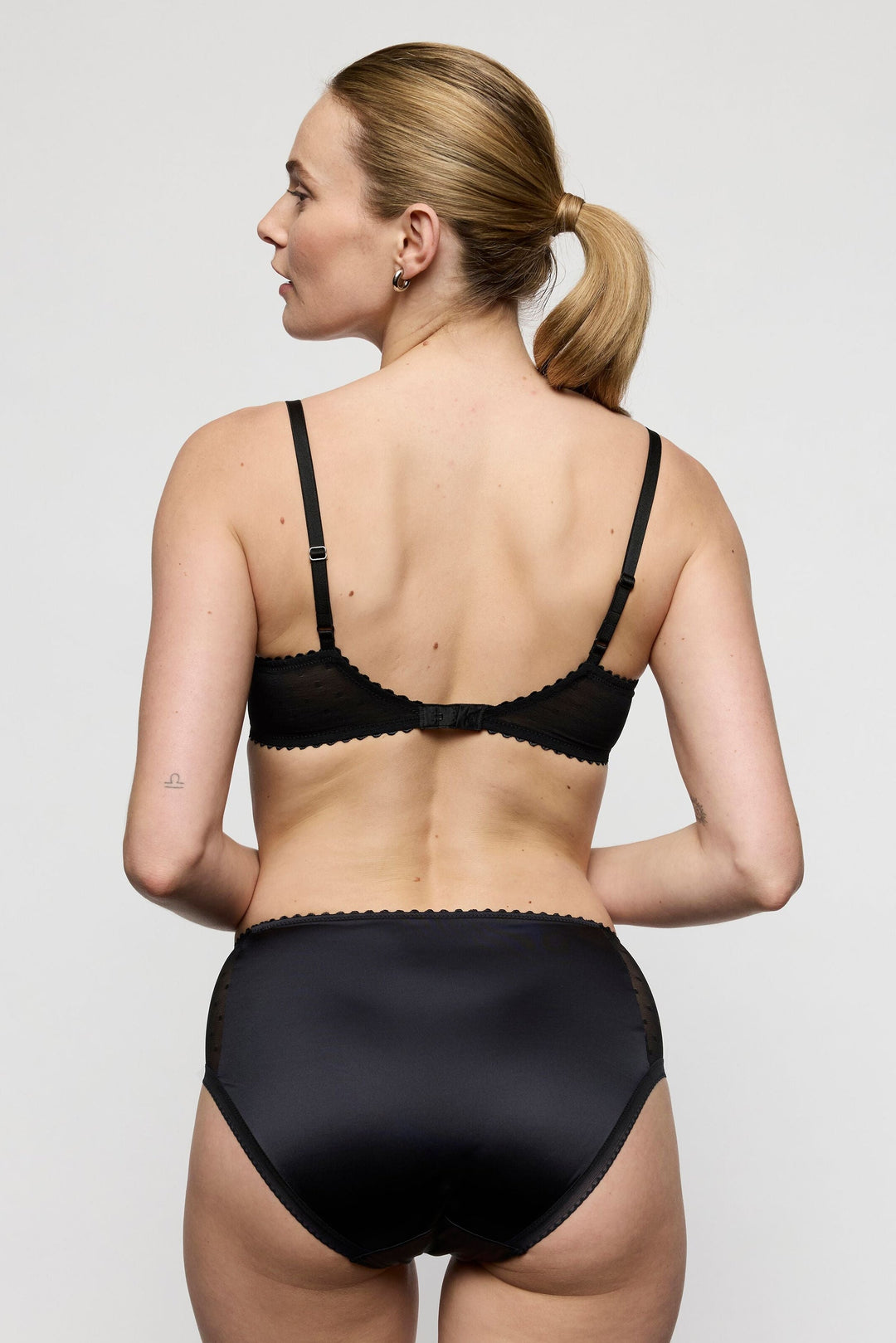 woman wearing the matching Noova full brief in black. sexy mesh lace with floral detail on the side. Retro style, featuring sexy boudoir look.