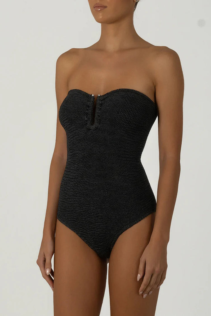 Black strapless swimsuit worn by a model on a white background
