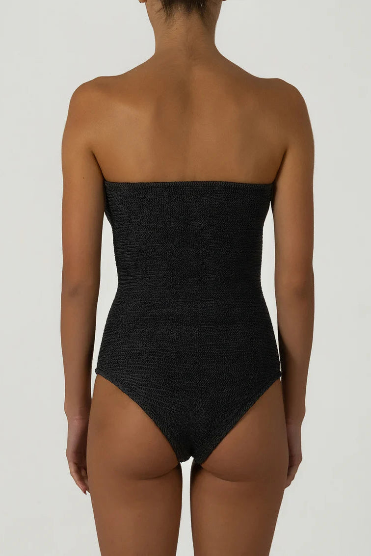 Black strapless swimsuit worn by a model on a plain background