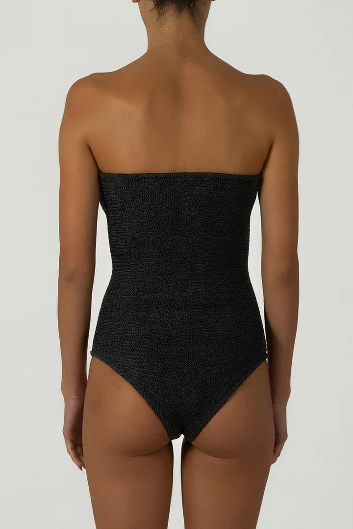 Black strapless swimsuit worn by a model on a plain background