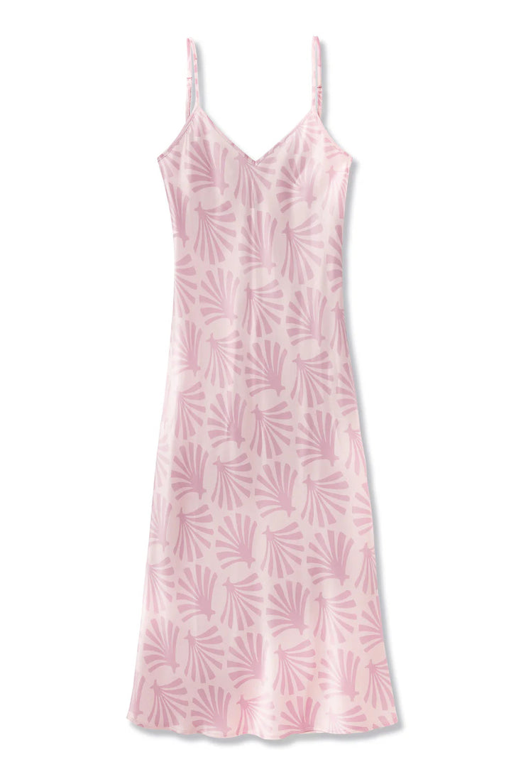 Pink silk slip dress with leaf pattern on a white background