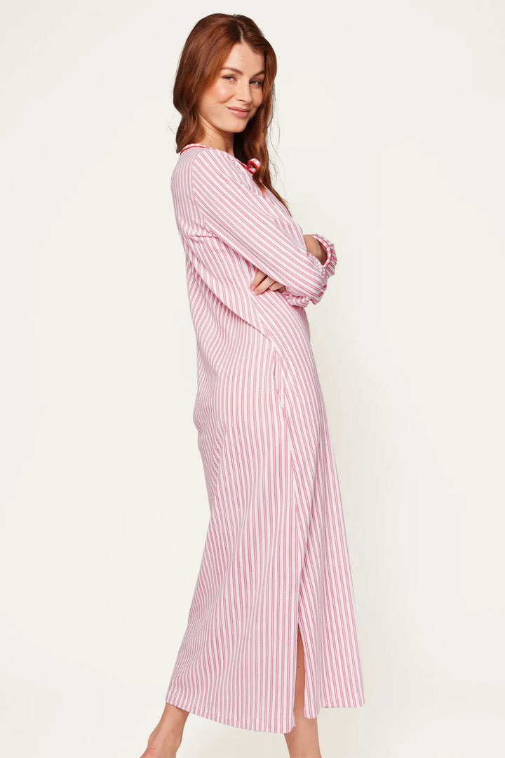 Woman wearing a red and white striped dress on a plain background