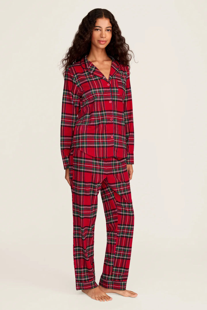 Woman wearing red plaid pajamas on a white background