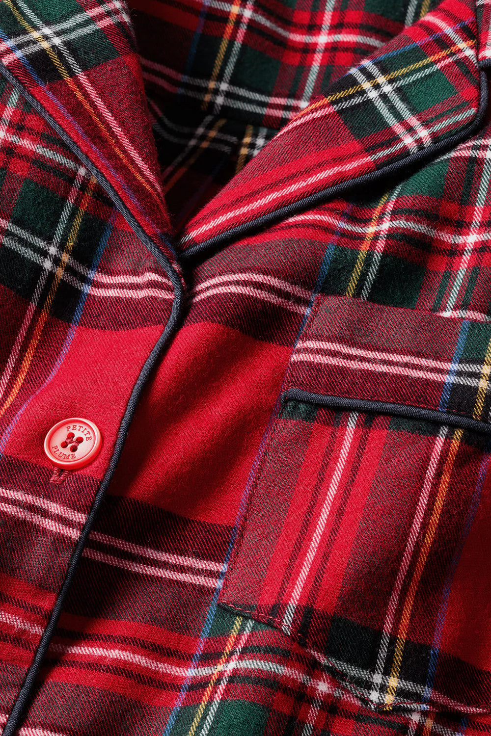 Close-up of a red plaid fabric with a button detail