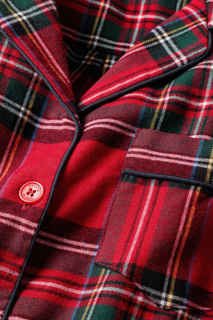Close-up of a red plaid fabric with a button detail