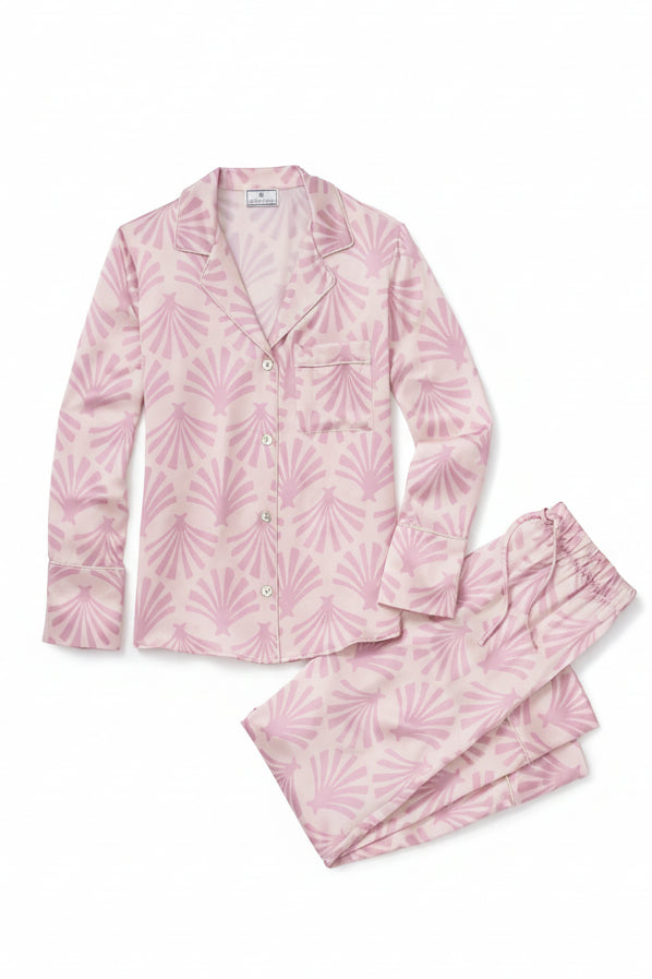 Pink silk pajama set with leaf pattern on a white background