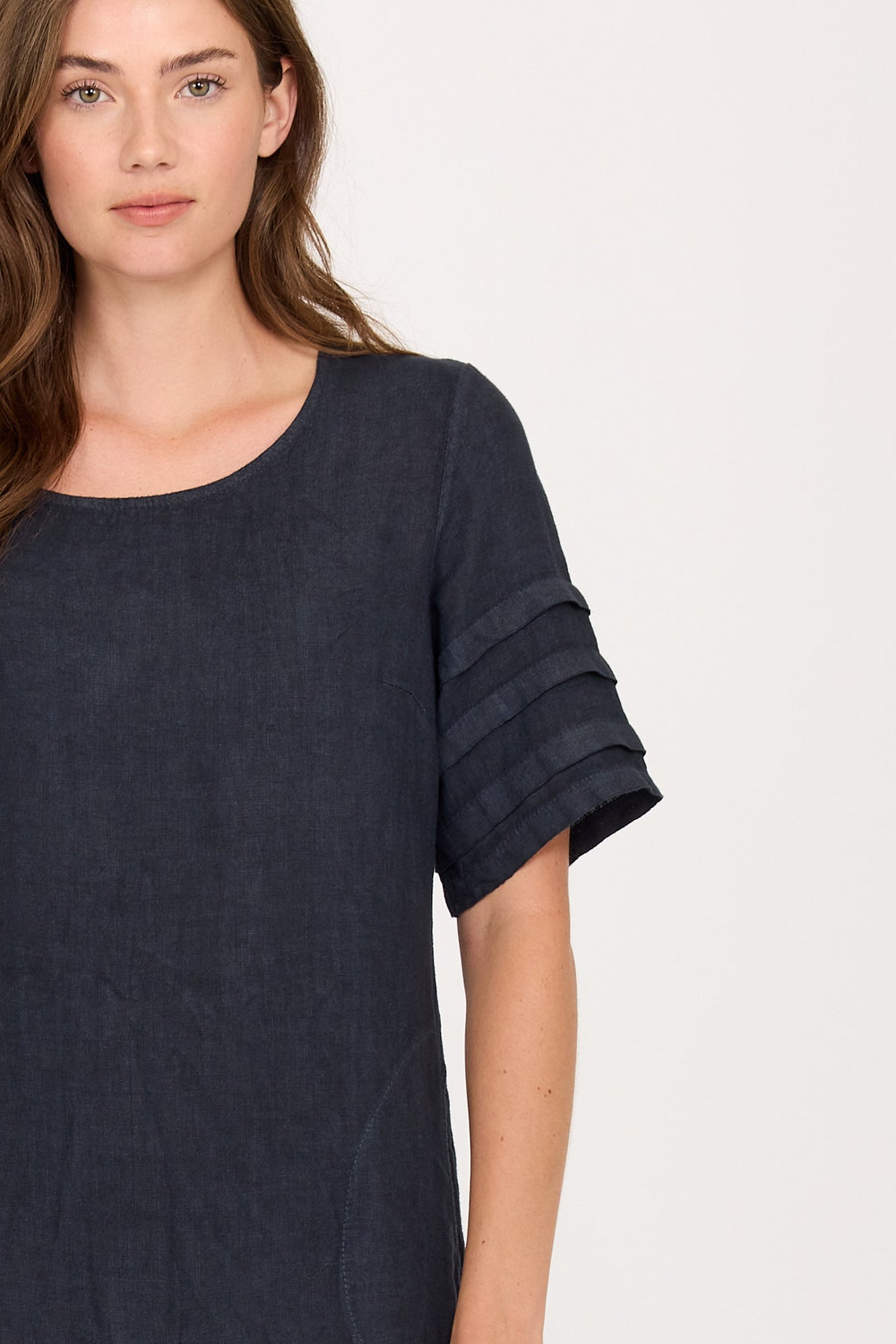 Woman in linen dres with sleeve details.