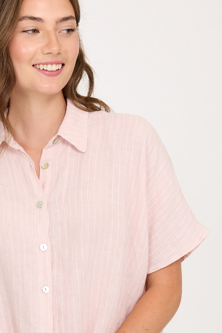 woman in pink linen striped shirt