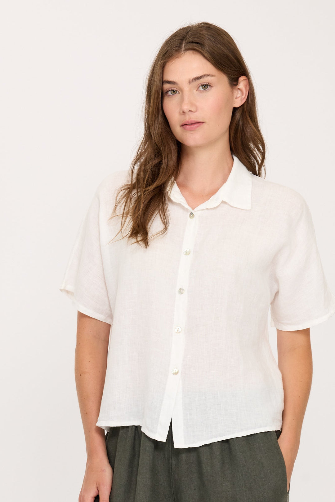 Woman wearing button down linen down. Easy summer and vacation clothing. Breathable and lightweight.