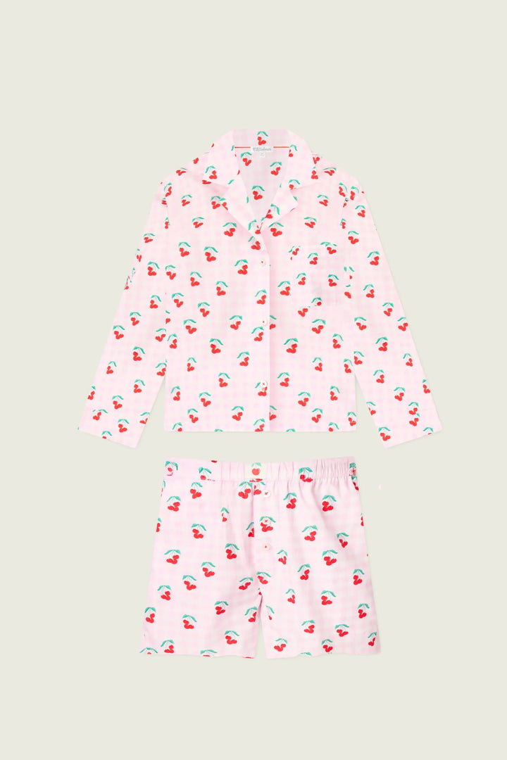 Pink pajama set with cherry pattern on a light gray background
