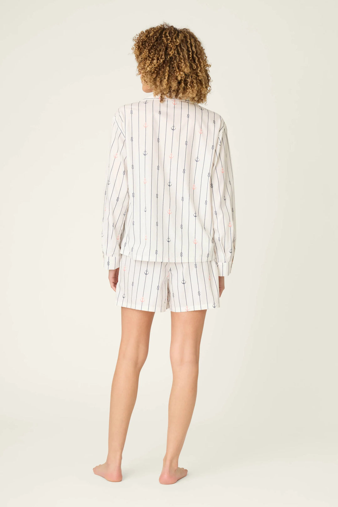 Person wearing a striped pajama set on a white background