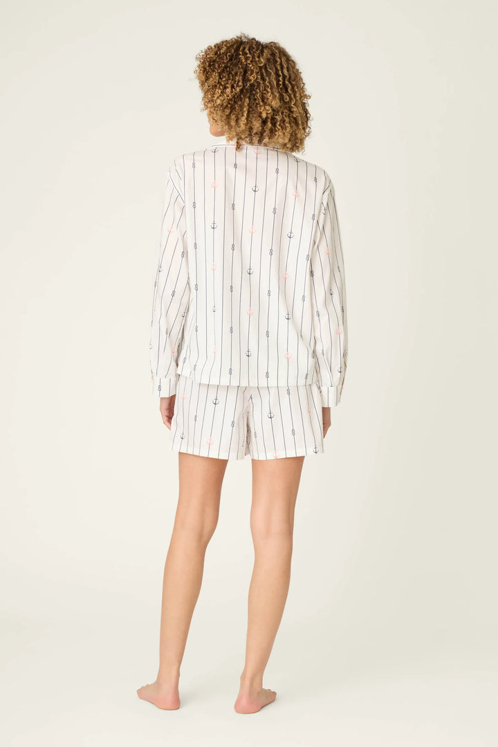 Person wearing a striped pajama set on a white background