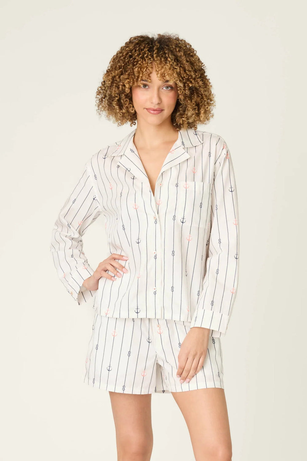 Woman wearing a striped pajama set on a white background