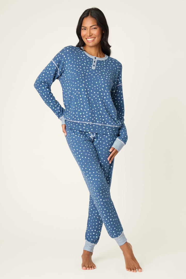 Woman wearing blue floral pajamas on a white background