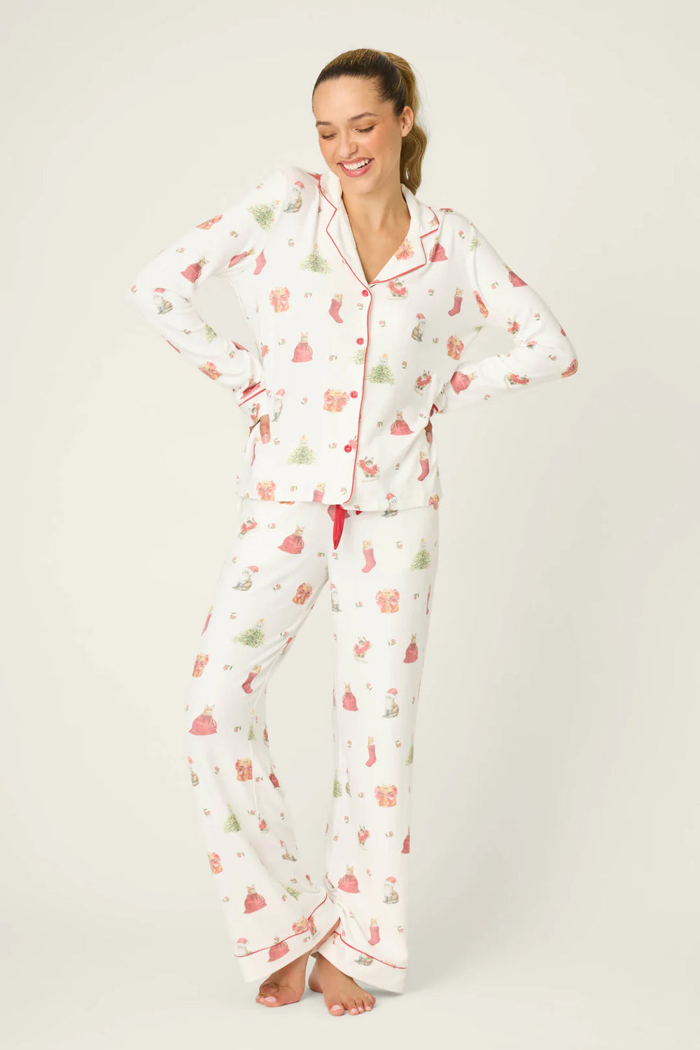 Woman wearing a patterned pajama set on a plain background