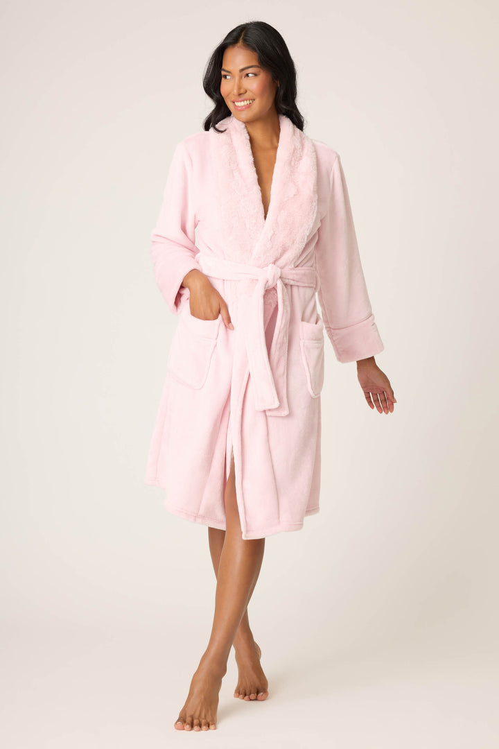 Woman wearing a pink robe on a white background