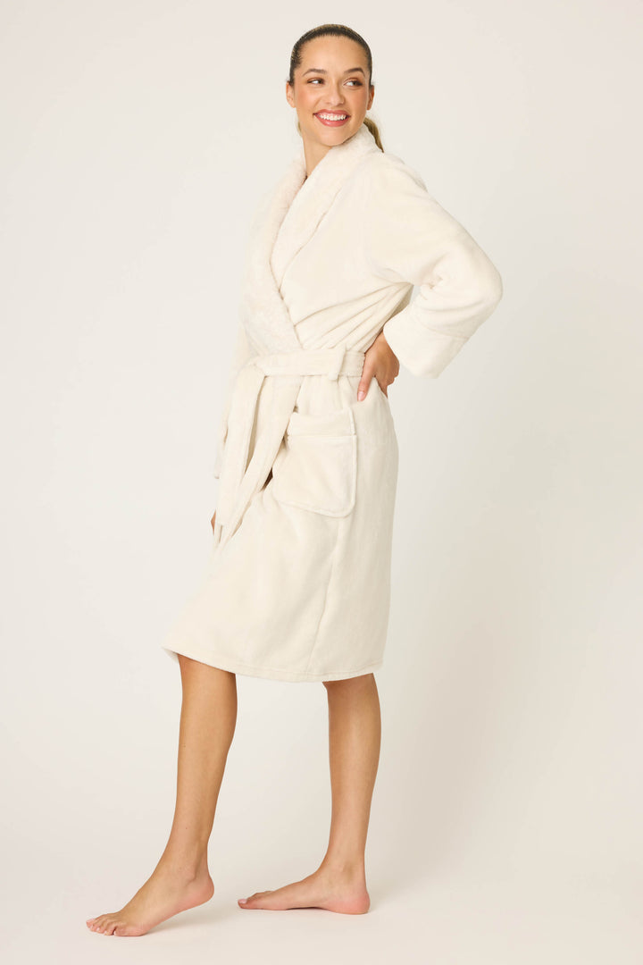 Woman wearing a cream robe on a white background