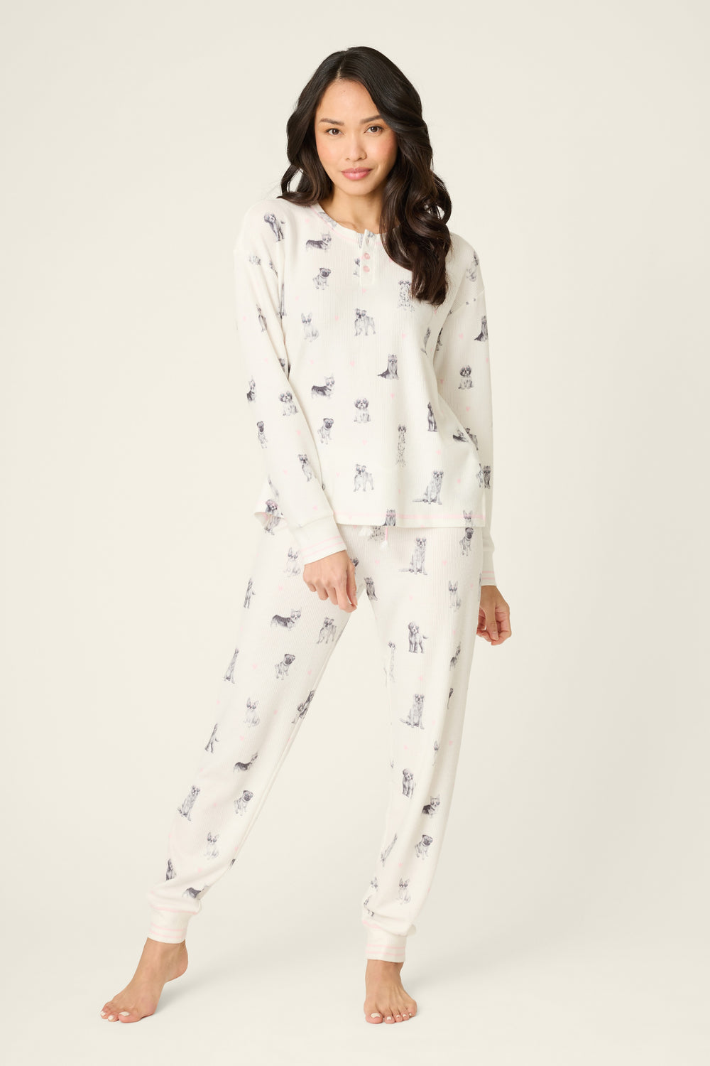Woman wearing a white pajama set with small prints on a white background