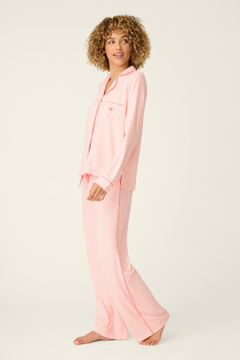 Woman wearing pink pajamas on a white background