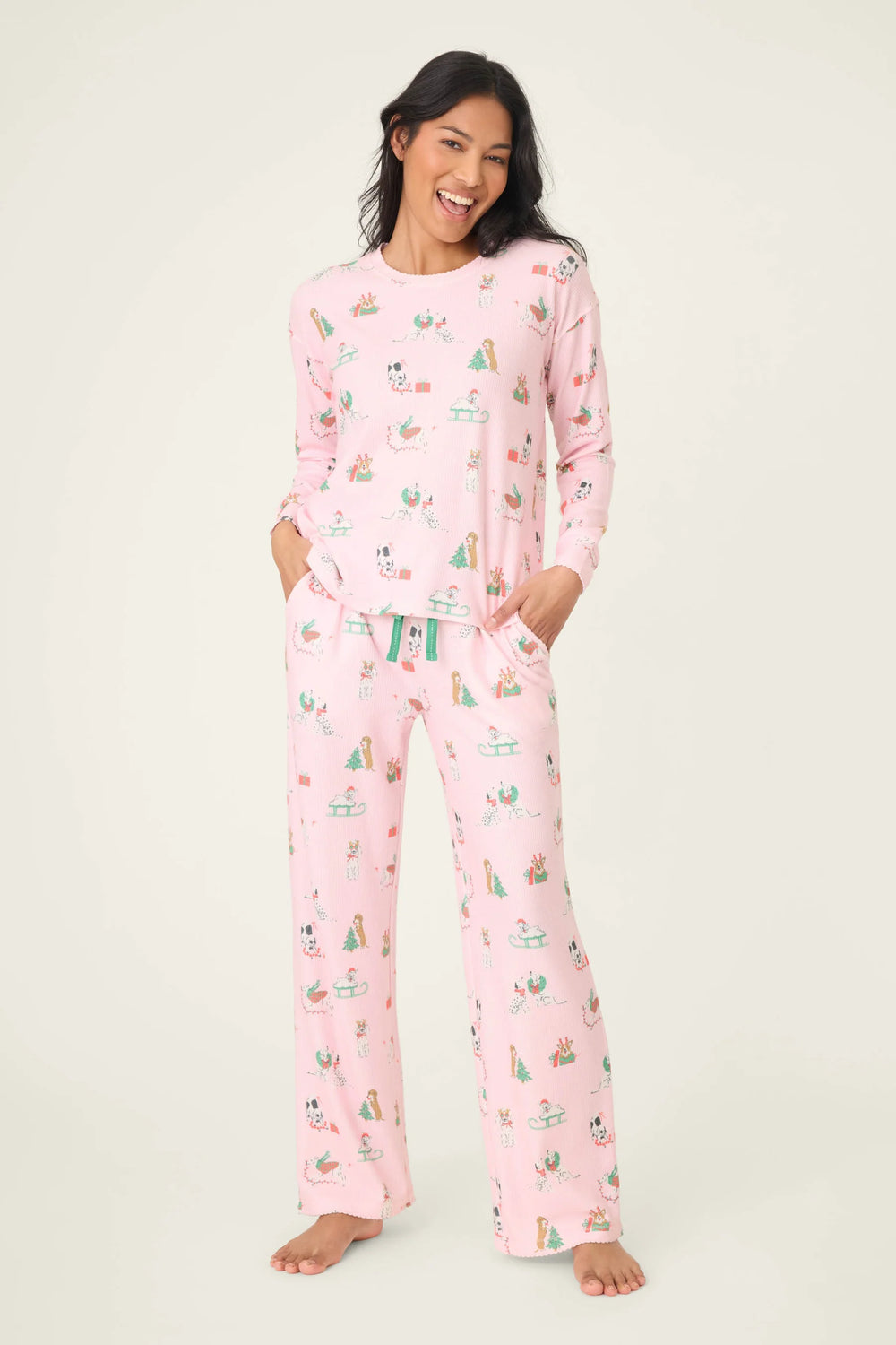 Woman wearing pink pajamas with a cactus pattern on a white background