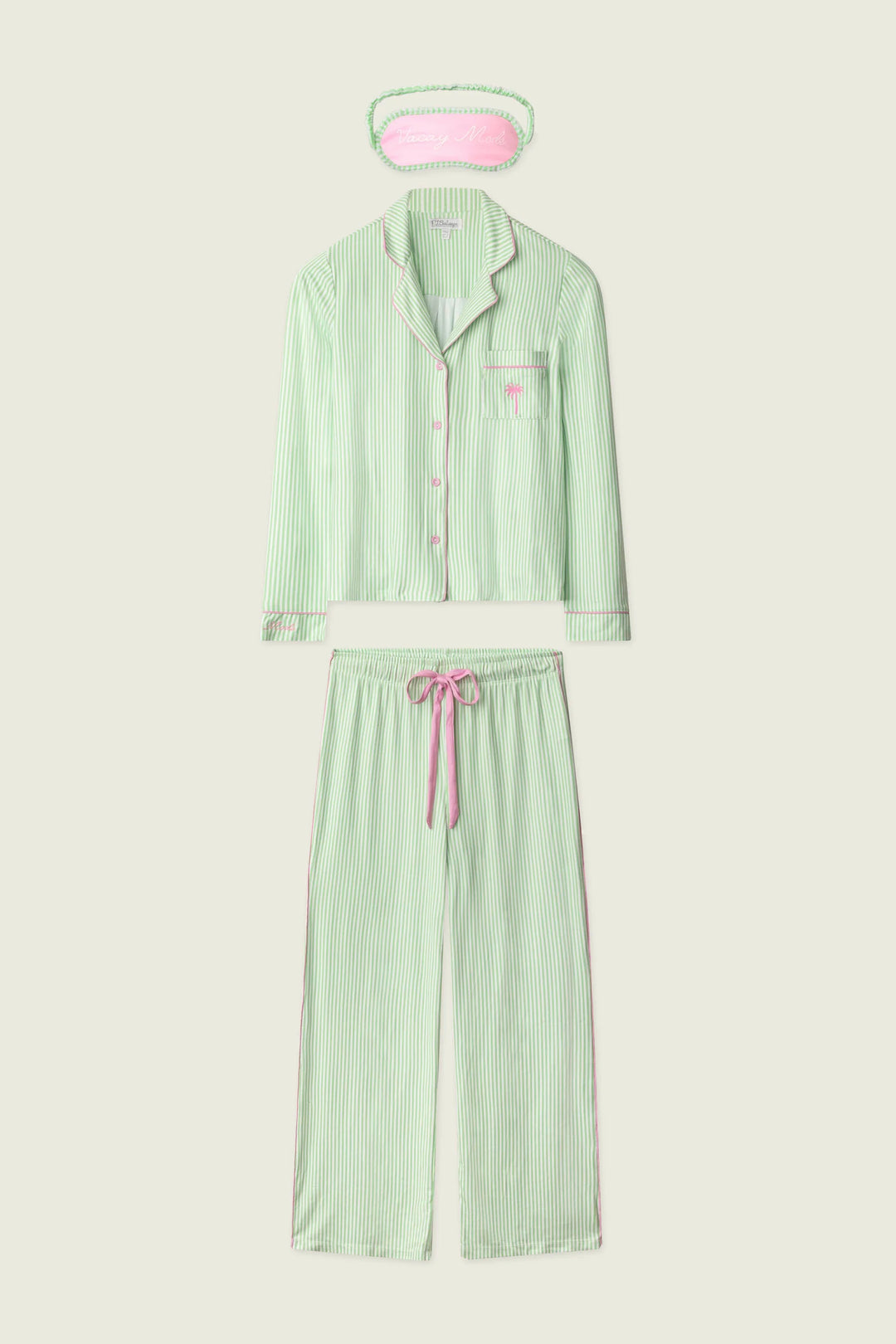 Green pajama set with matching eye mask on a white background