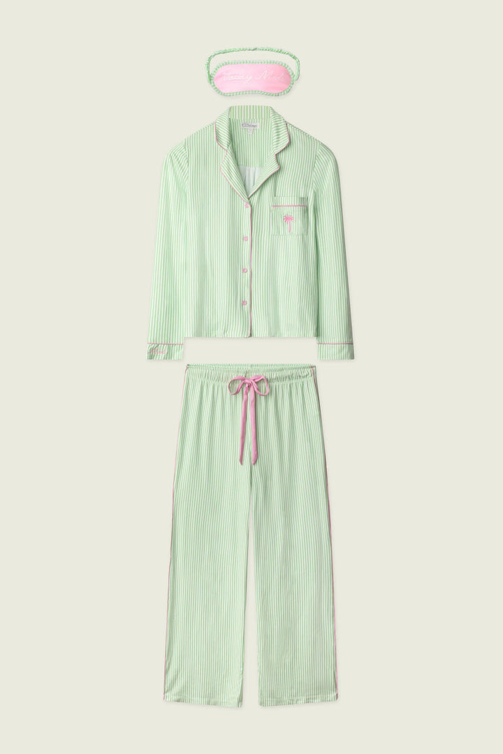 Green pajama set with matching eye mask on a white background