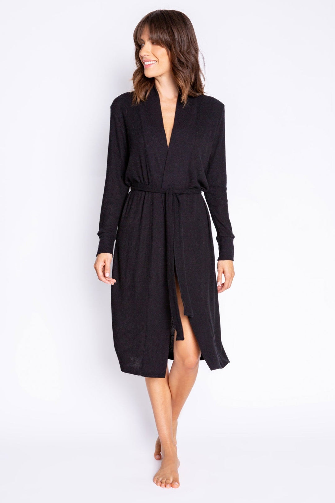 Woman wearing a black long-sleeve robe on a white background