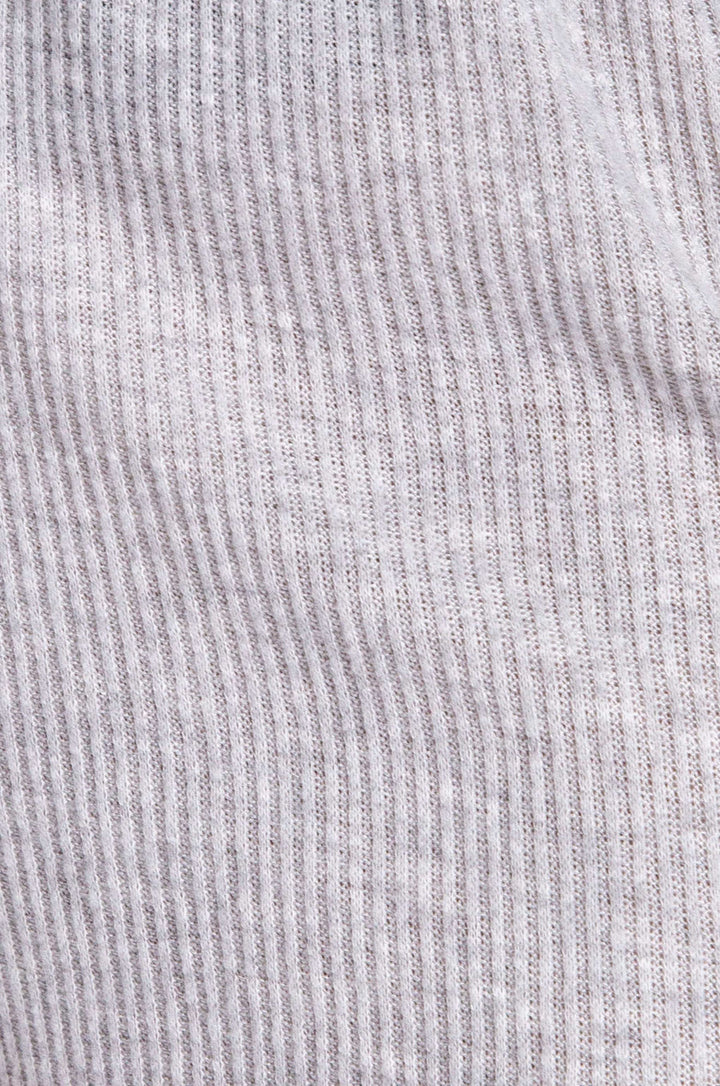 Close-up of a ribbed knit fabric with vertical stripes in light gray and white.