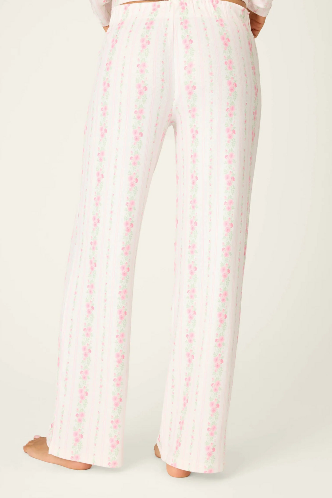 White pajama set with pink floral pattern on a white background