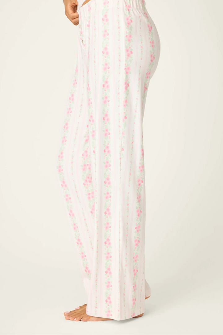 White pajama set with pink floral pattern on a white background