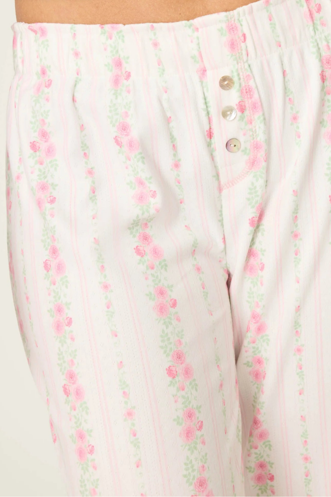 Floral patterned pajama set with a close-up of the pants on a white background