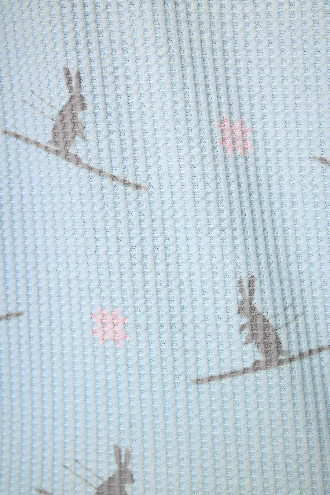 Textile with rabbit pattern on a light blue background