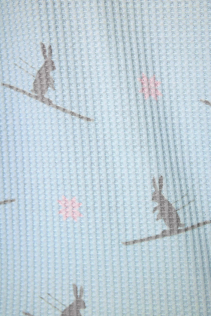 Textile with rabbit pattern on a light blue background