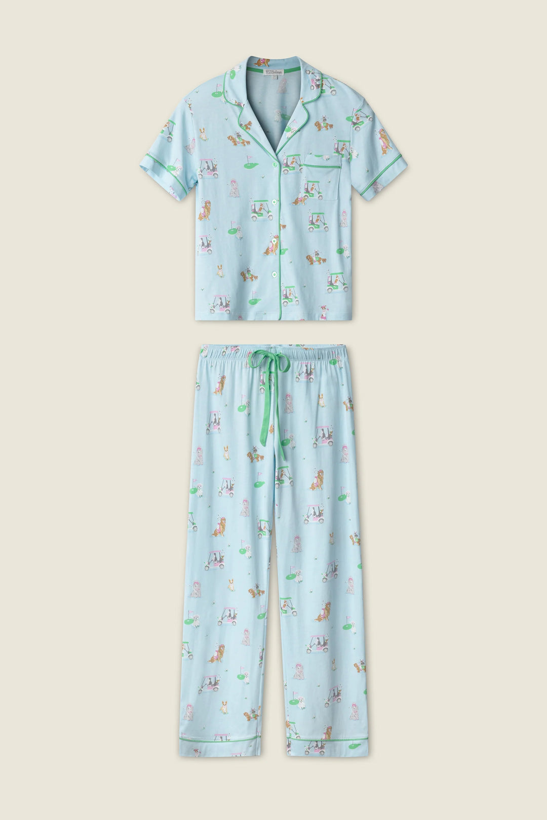 Woman wearing a light blue pajama set with dog print on a plain background