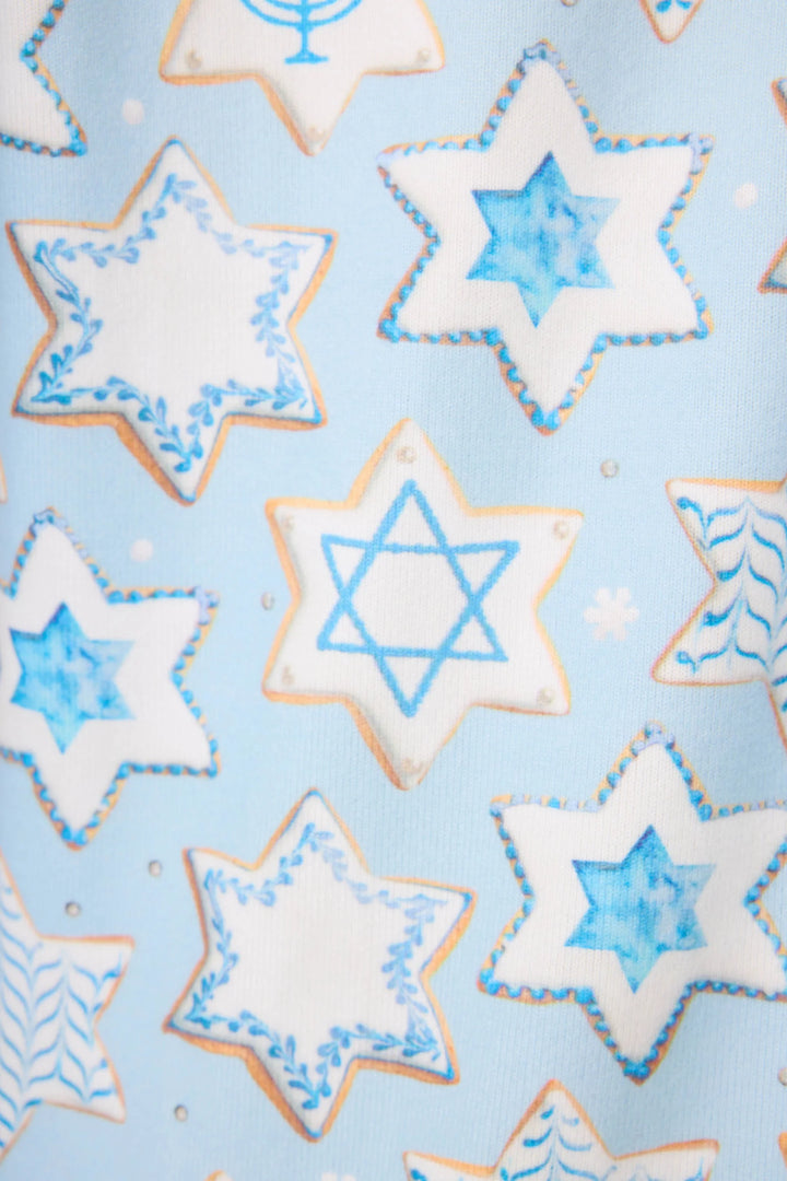 Star-shaped cookie print with blue icing on a light blue background
