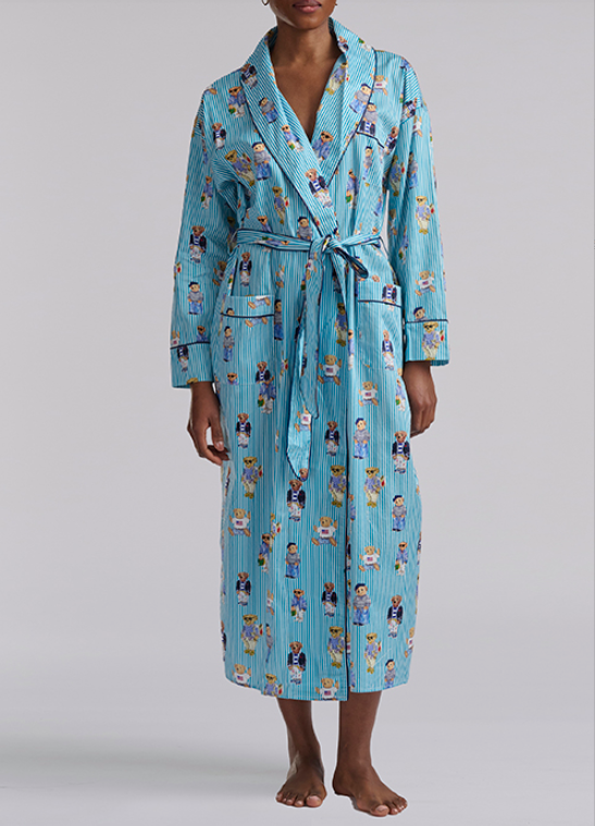 Person wearing a blue polo ralph lauren teddy bear patterned robe on a plain background