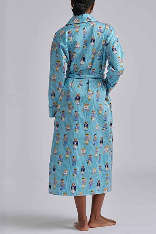Person wearing a blue polo ralph lauren teddy bear patterned robe on a plain background
