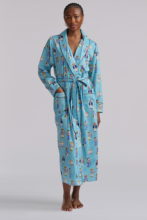 Person wearing a blue polo ralph lauren teddy bear patterned robe on a plain background