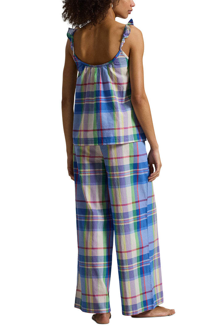 Woman wearing a plaid pajama set on a white background