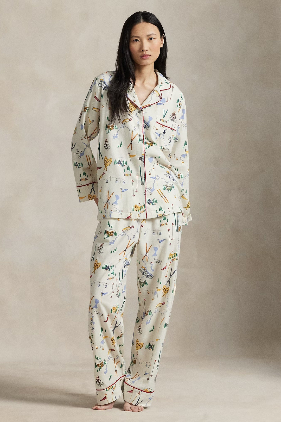Woman wearing a ski pajama set against a neutral background